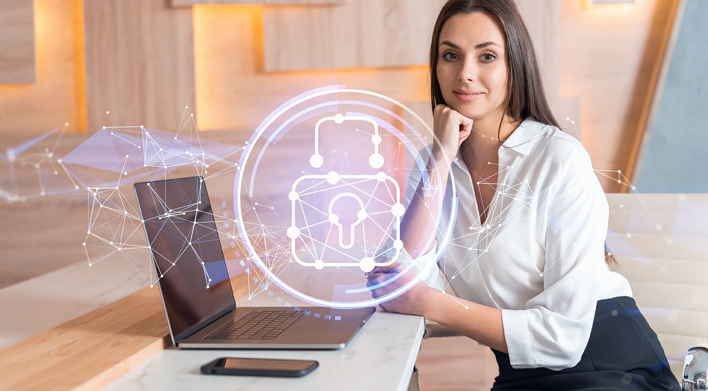 businesswoman in white shirt at workplace working with laptop to defend customer cyber security. Concept of clients information protection. Padlock hologram over office background